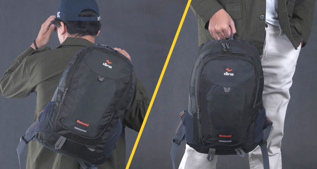 Pria menggendong tas ransel Outvin TL 795 warna hitam di punggungnya dan pria berpose menenteng tas yang sama di depan kakinya.